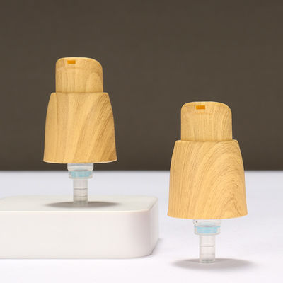 Pompes à lotion en plastique sans air à ressort externe 0,25 cc Pompes à lotion pour les mains avec grain de bois